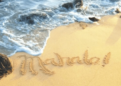 Mahalo written in the sand